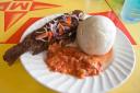 Banku served with fried tilapia from the Volta River and a tomato sauce
