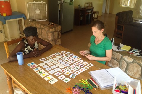Heidi works with our language helper to learn Mampruli vocab